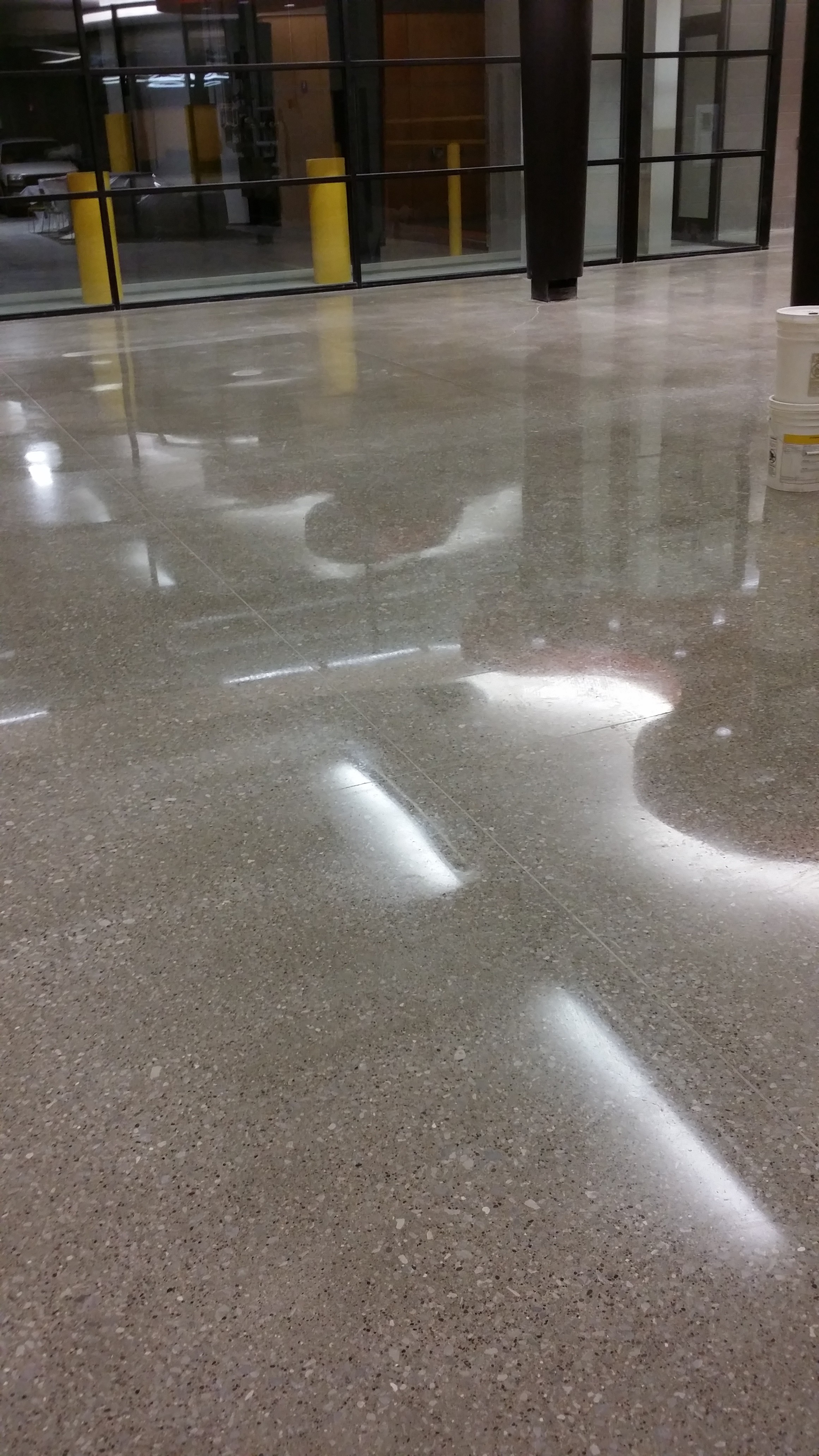 Commercial high gloss floor at MetroLINK that is so shiny, you can see the ceiling.