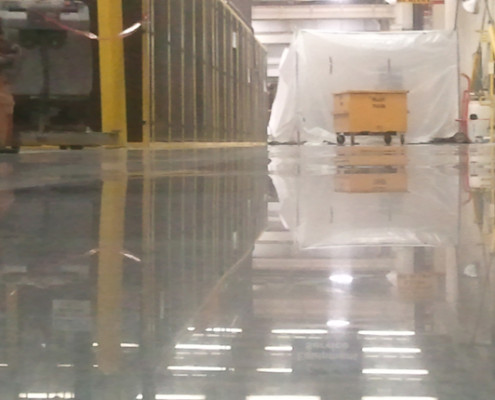 Floor polishing at automotive manufacturing company.