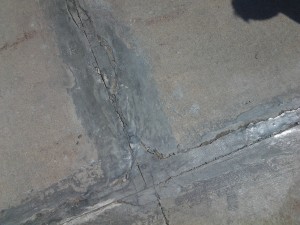 Improperly repaired concrete floor joint failure