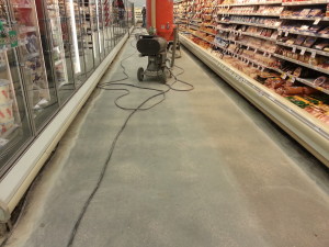 In process VCT (Vinyl Composition Tile) tile removal at grocery store in Iowa City IA with no edge work